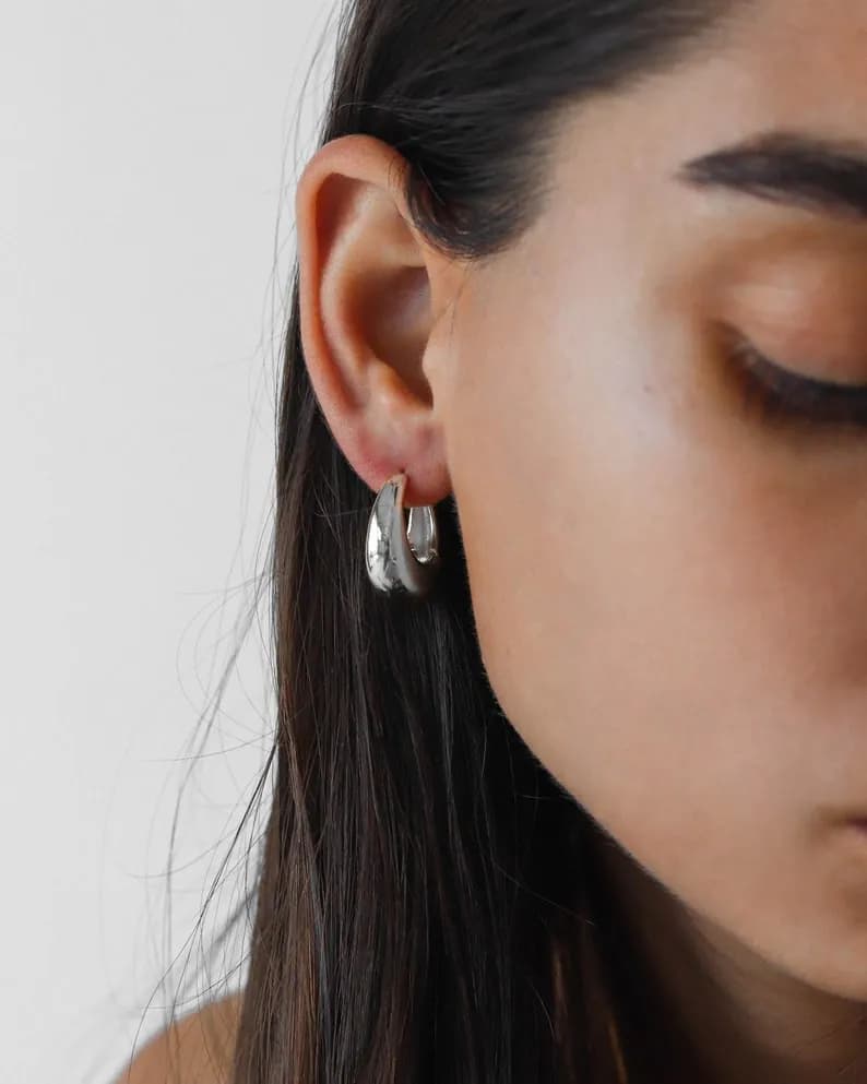 Stylish silver hoop earrings with a hammered texture.